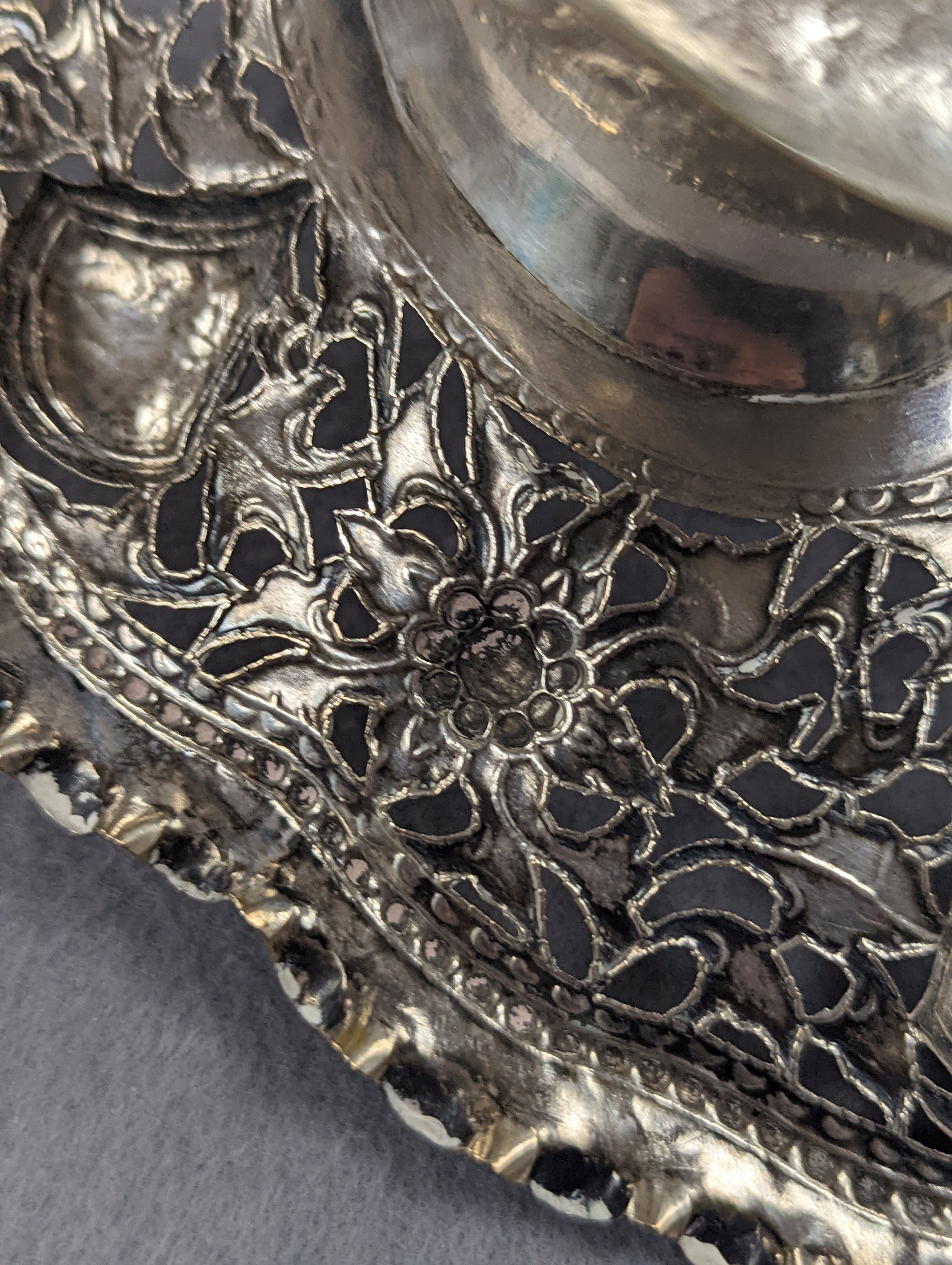 A Chinese pierced and embossed white metal shaped oval pedestal basket, length 21.6cm, 9oz, signed on base.